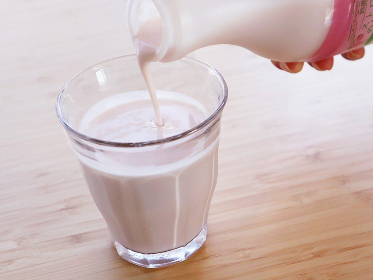 『鈴鹿山麓ストロベリーのむヨーグルト』を注いでいる