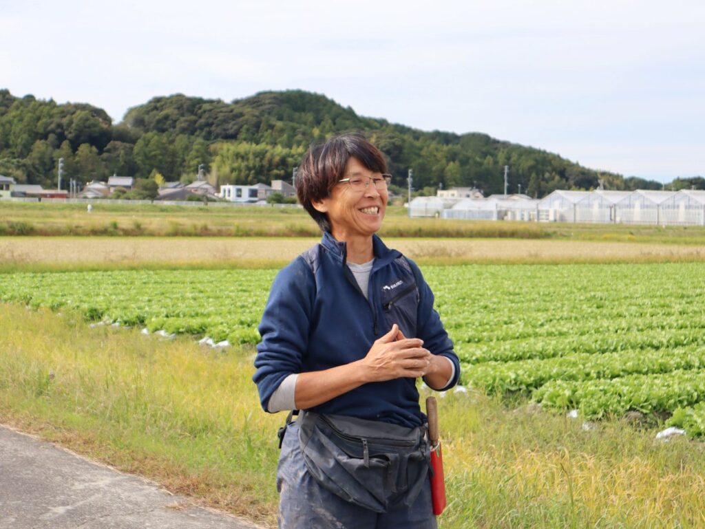眼鏡をかけた野菜くらぶの方（塚本さん）が笑っている写真