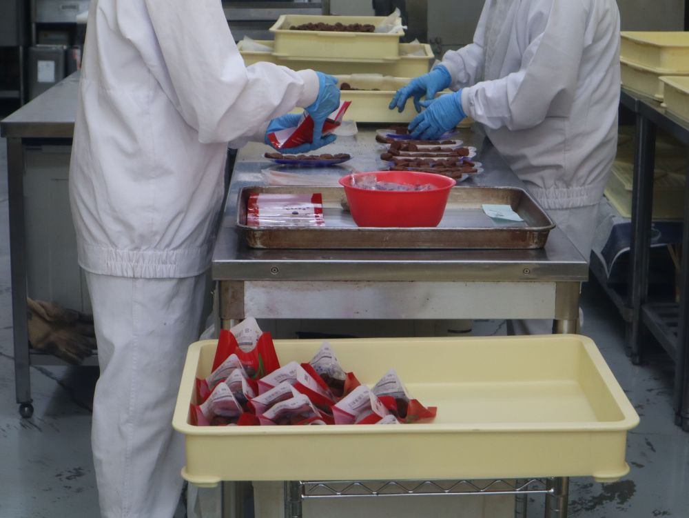 手作業で13粒ずつ袋詰めする